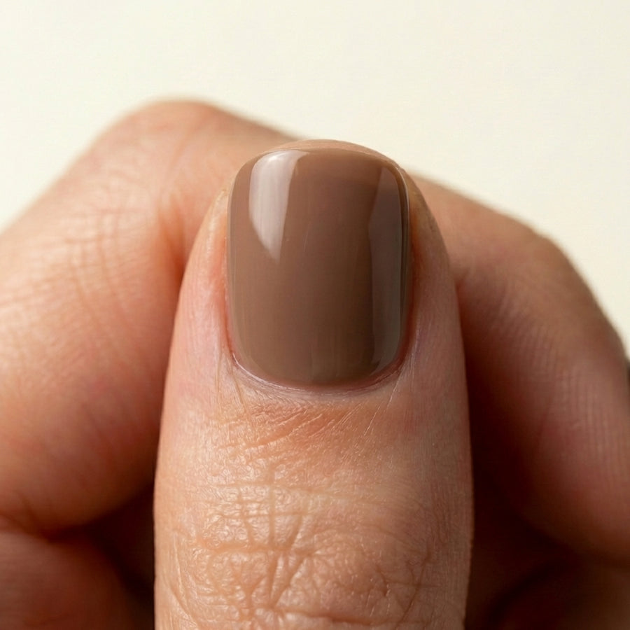 Close-up of Soft Mocha short oval Hushed reusable soft-gel press-on nails.